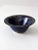 This vintage studio pottery bowl is signed by the artist and showcases a rich, variegated blue glaze. The handmade piece...