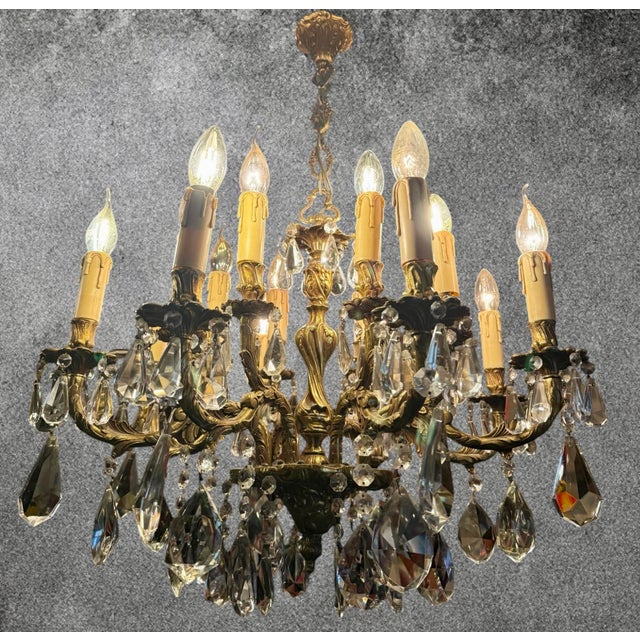 Exceptional french louis xv / rococo style chandelier featuring sixteen light points and an elaborately cast gilt bronze...