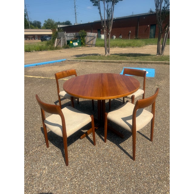 Ansager Møbler Teak Dining Table + Set of Møller 77 Dining Chairs This is a Danish modern masterpiece that blends...