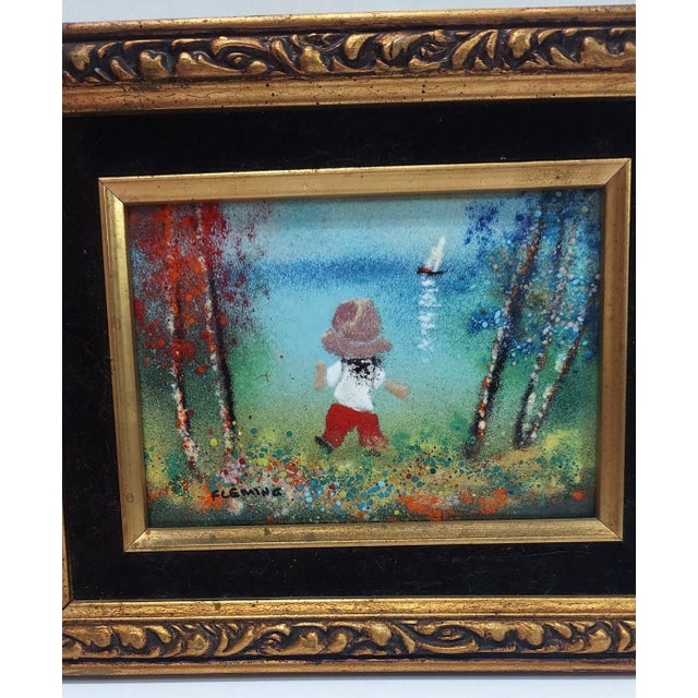 Sweet enameled painting on copper. Playful child with a toy sailboat on the water on a fine autumn day. Signed Fleming....