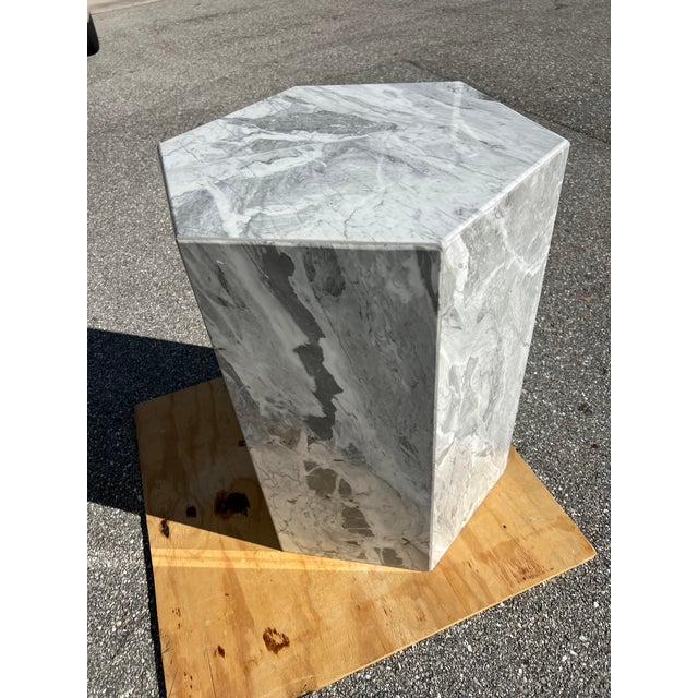 Marble dining table with an octagonal Italian design and round glass top. 1970s. The raw marble features beautiful white...