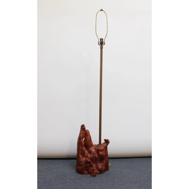Driftwood floor lamp with patinated brass stem (circa 1950s, USA). Organic form with dense textures and dark stain which...