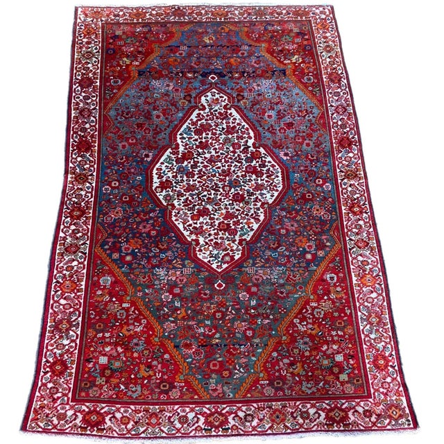 An exceptional antique Mishan Malayer rug, handwoven circa 1900 with an ivory medallion on an unusual light indigo field...