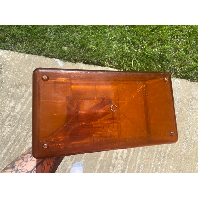 The product is a vintage burnt orange acrylic Wil-Hold sewing box storage unit, made by Willson MFG CORP. designed for...