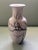 A classic urn shaped vase with a cherry blossom pattern.