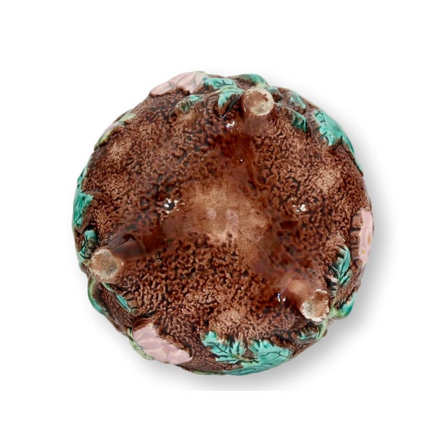 19th century English majolica bowl featuring richly modeled naturalistic decoration with leaves and fruit set against a...