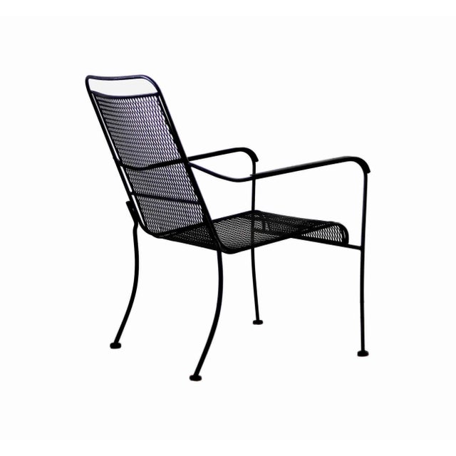 Set of six vintage black iron armchairs. Solid iron with perforated metal seats/backs. • The set of chairs is stackable.