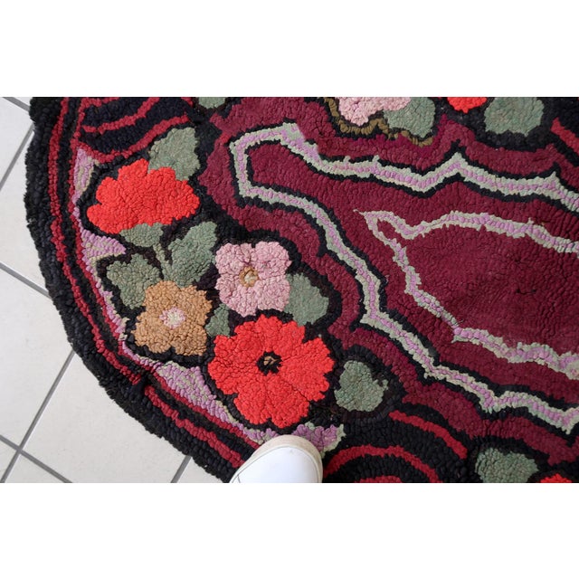 Handmade antique American Hooked rug in floral design and black background. The rug is from the beginning of 20th century....