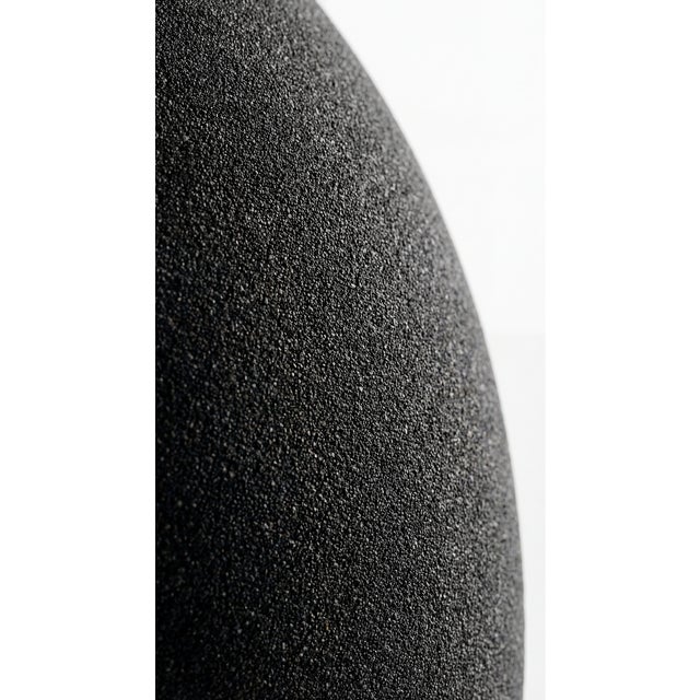 The Stryde Console Table is a sculptural entryway piece 3D-printed from black quartz sand. Two flowing legs sweep forward...