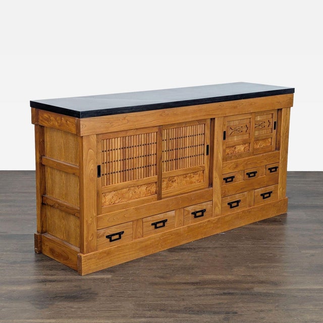 This antique tansu credenza/sideboard has a solid wood case with carved burl-wood door panels. The sliding lattice...