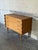 This striking dresser features a compact silhouette defined by elegantly scalloped side panels. Three spacious drawers...