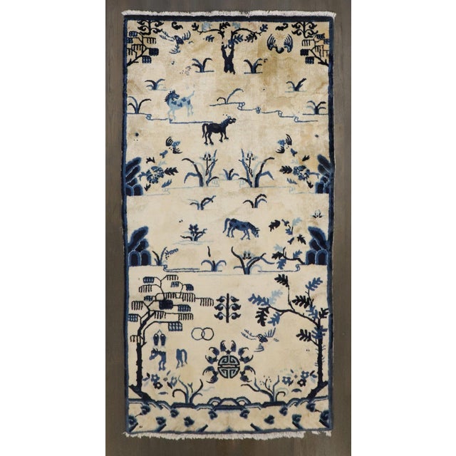 An early 20th-century Chinese Peking carpet with an animal motif in beige and blue circa 1910, measures: 3' x 5'8".