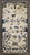 An early 20th-century Chinese Peking carpet with an animal motif in beige and blue circa 1910, measures: 3' x 5'8".