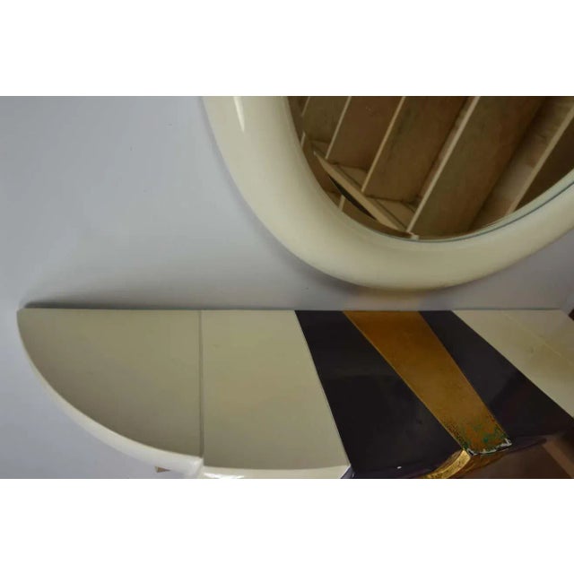 Art Deco style wall console and mirror with a lacquer finish. Heavy composition construction. Measures: Mirror 35" H,...