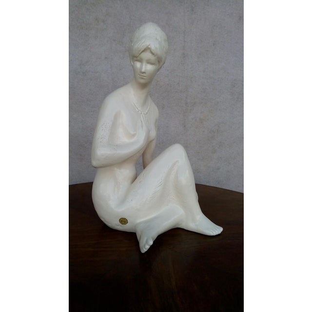 A beautiful glazed ceramic sculpture by Bohumil Kokrda from mid-century Czechoslovakia. The statue of a seated girl is in...