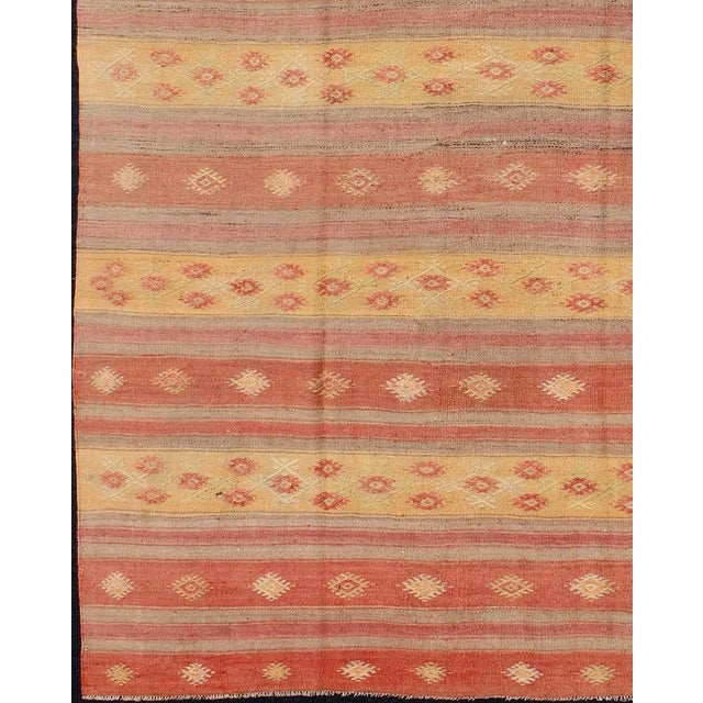 Keivan Woven Arts, En-140546, Vintage Mid-Century Turkish Kilim Rug. Featuring geometric tribal shapes rendered in a...