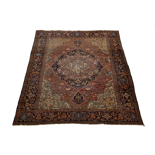 This beautiful hand-knotted wool Sarouk Farahan rug features a navy blue and rust color field. It is framed with...