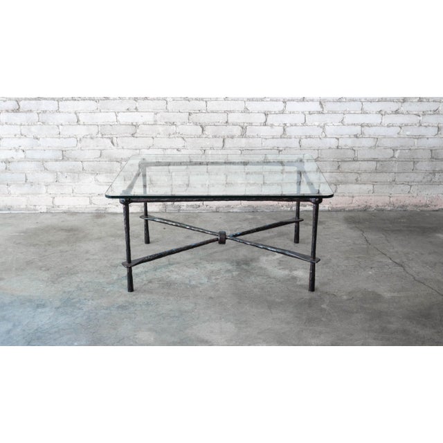 Vintage Brutalist Diego Giacometti attributed iron and glass coffee table, circa 1980s. Hand forged frame and thick heavy...