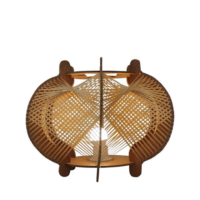 Scandinavian Modern table lamp produced in the 1960s, distinguished by its sculptural wooden construction and refined...