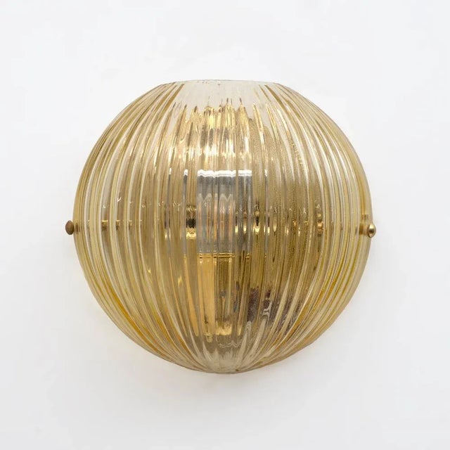 Pair of Vistosi wall lamps in blown Murano glass with gold dust. Each lamp holder has an E26 fitting for the United States...