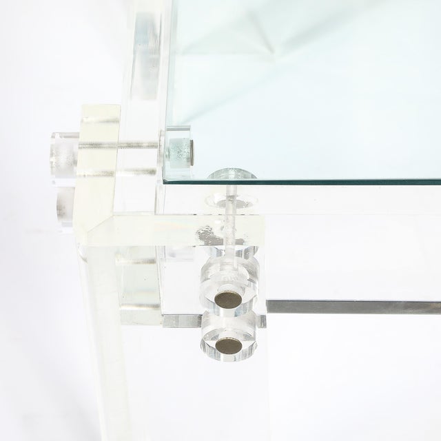 This pair of mid-century modernist rectilinear Lucite and glass side or end tables captures that clean, weightless 1970s...