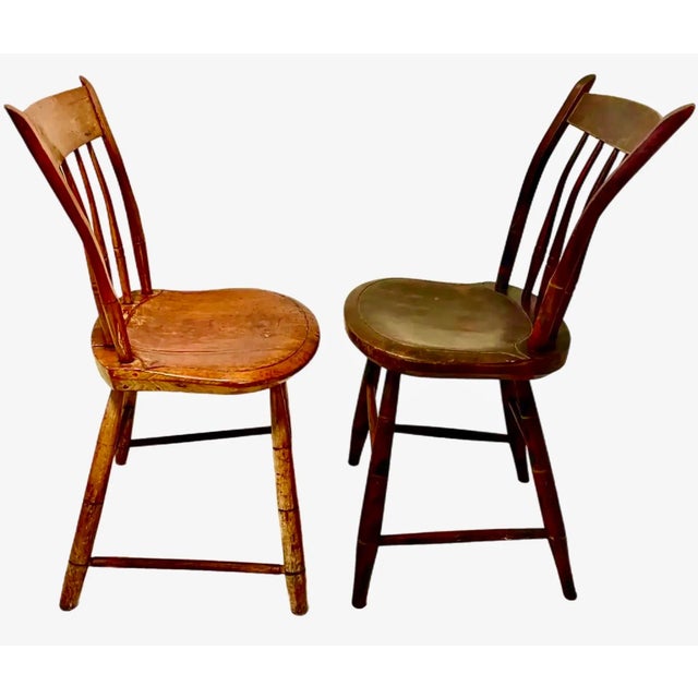 A complementary pair of late 1700s to early 1800s New England rod back Windsor chairs. The first chair retains its...