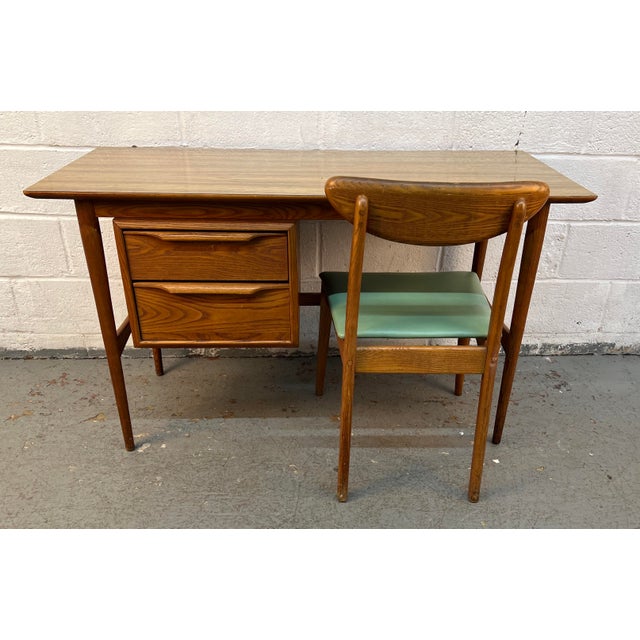 Bring timeless Mid-Century Modern style to your home, office, or study with this authentic 1960s Heywood-Wakefield student...