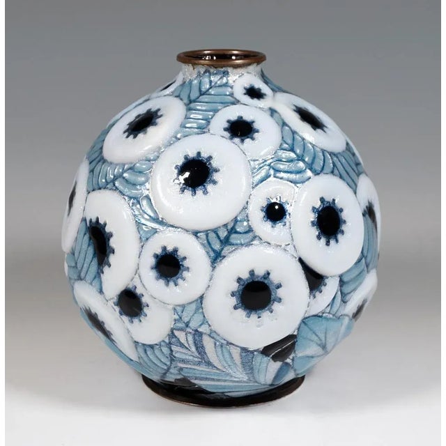 Spherical vessel on a round, grooved metal stand, coated in silver and with pasty applied, polychrome and iridescent...