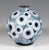 Spherical vessel on a round, grooved metal stand, coated in silver and with pasty applied, polychrome and iridescent...