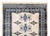 A late 20th century Pakistani Bokhara runner with many large diamond medallions and repeated stylized floral motifs...