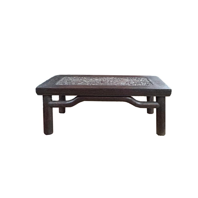 This exquisite low table, or kang table, showcases the refined aesthetics of traditional Chinese furniture with its dark,...