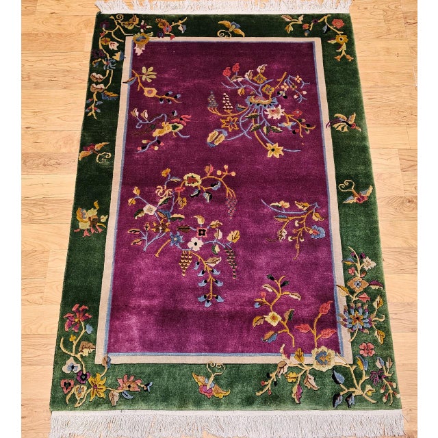 Striking and elegant, this vintage Chinese Art Deco area rug features an allover floral pattern set against a rich royal...