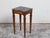 A French Neoclassical style wooden side table from the 19th century, with grey marble top and fluted legs. Created in...