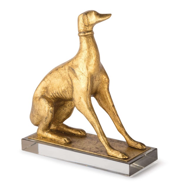 Perched atop a crystal pedestal, this pair of left and right facing dogs, are finished in antiqued gold leaf and perfect...