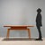 Italian-made 1960s table crafted from oak wood, featuring a minimalist design that reflects the period's style. The top is...