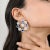 Discover the elegance of these exquisite swirl-shaped Kyanite and 6.13 ctw Diamond Wedding Stud Earrings. Featuring a...