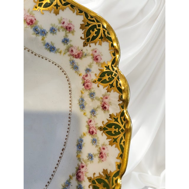 Hand-painted Limoges Depose divided dish featuring delicate blue forget-me-nots, pink roses, and raised gold gilt...
