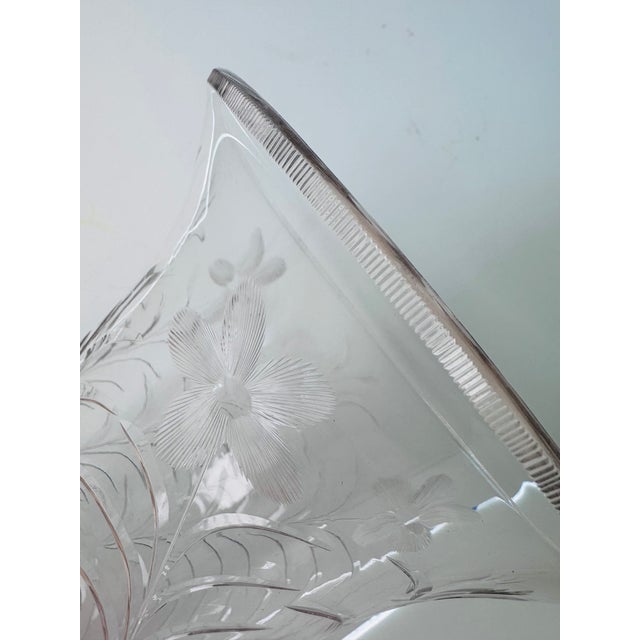 A wonderfully tall vase etched with long branches spiraling to the top with flowers. This piece dates to the early 20th...