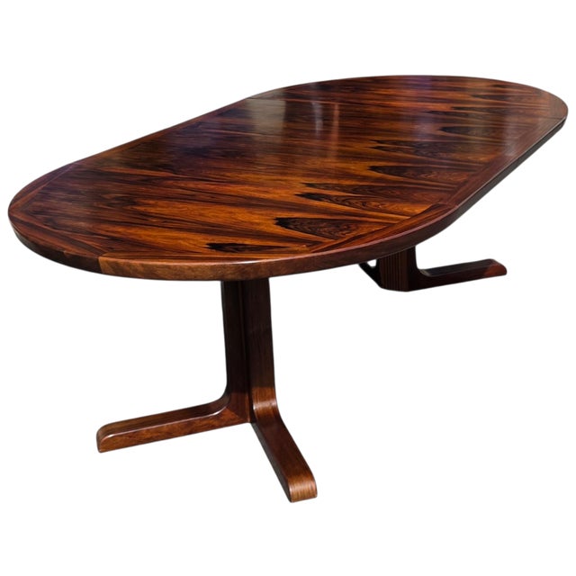 This Danish Modern Rosewood Two-Leaf Dining Table with Sculptural Pedestal Base and Expanding Mechanism is a gorgeous,...