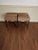 A Pair of mahogany benches. Recently upholstered with faux leopard leather with brass nailheads. Benches have Chinese...