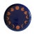 A handmade stoneware plate with a terra cotta-colored base with deep blue and a border of moon phases. 9.2"