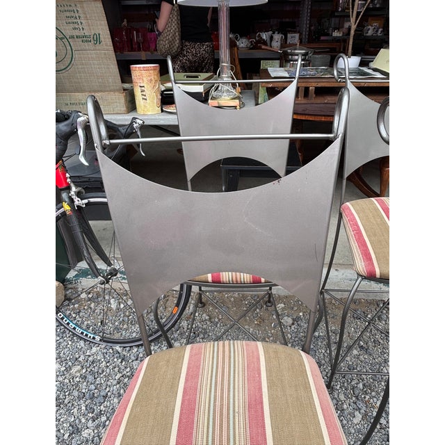 Mid-Century Modern bar stools designed for indoor or covered patio use. They feature a distinctive "bowtie" or "hourglass"...