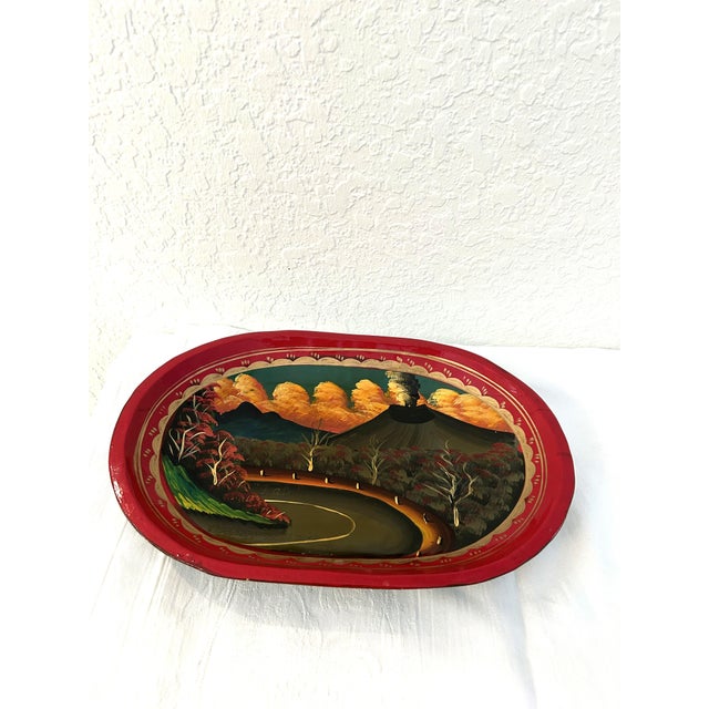 Colorful carved wood shallow bowl with a hand-painted scene of Palín. Palin is a municipality in Escuintla, Guatemala,...