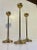A trio of tulip shaped brass candlesticks designed and manufactured in Scandinavia during the 1960s ina style reminiscent...