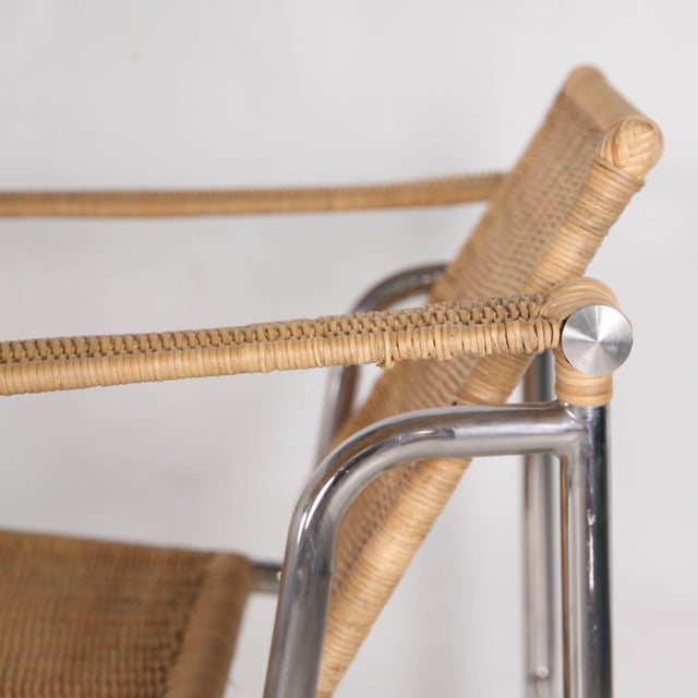 Rare pair of vintage chrome and woven wicker armchairs. Reclining backrests, deep and wide seats for exceptional comfort....