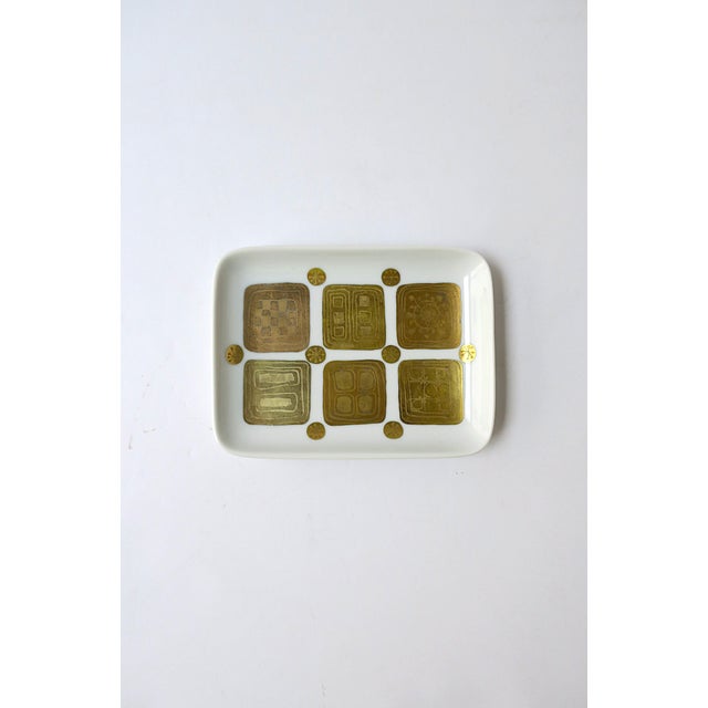 A German white, gold and copper porcelain jewelry dish by Danish Designer Bjorn Wiinblad for Rosenthal Studio-Line,...