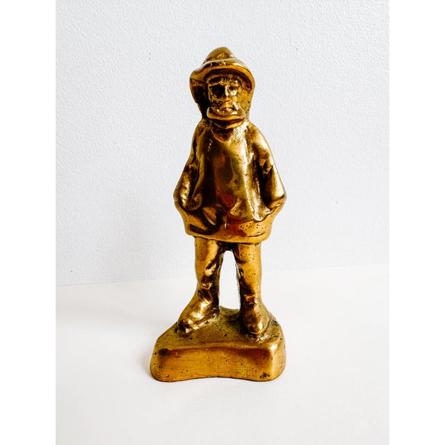 A fun quirky vintage brass fisherman with floppy had and his hands in his pockets. Solid brass and heavy. Would be cute as...
