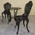 An exceptionally decorative cast iron garden set, comprising two matching chairs and a round table in a richly detailed...