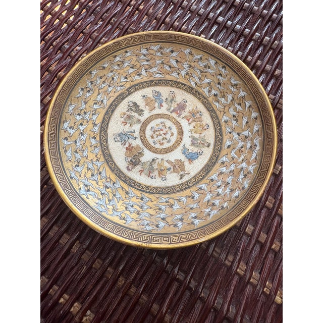 Meiji Period (1868-1912) Satsuma Teacup and Saucer with exquisite detail with immortals and butterflies, and cranes. On...