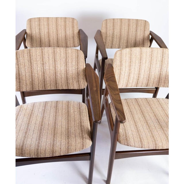 Set of four dining room chairs in teak and upholstered with striped fabric, of Danish design from the 1960s. The chairs...